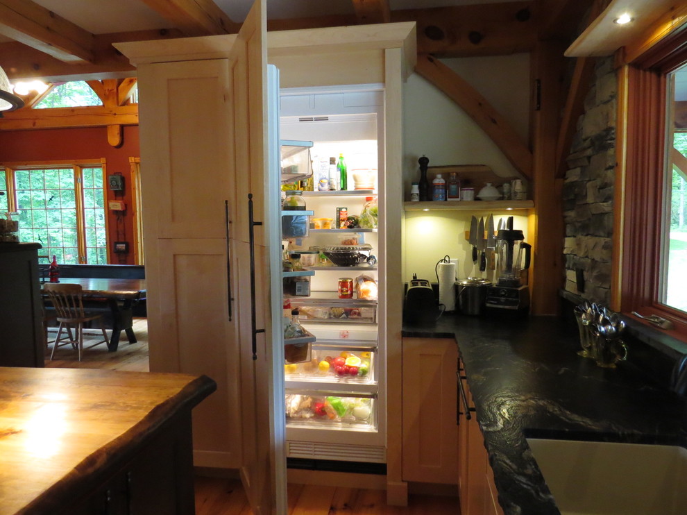Example of a large mountain style u-shaped light wood floor eat-in kitchen design in Toronto with shaker cabinets, granite countertops, stone tile backsplash, an island, an undermount sink, light wood cabinets, gray backsplash and stainless steel appliances