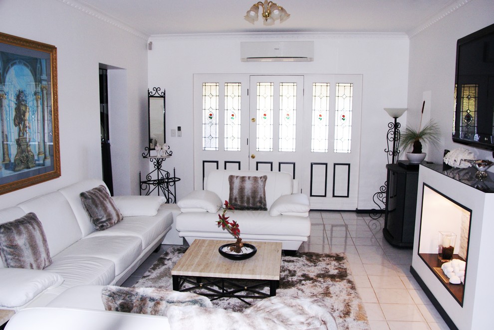 Photo of a large contemporary formal open concept living room in Other with white walls, porcelain floors, a standard fireplace, a tile fireplace surround, a wall-mounted tv and white floor.