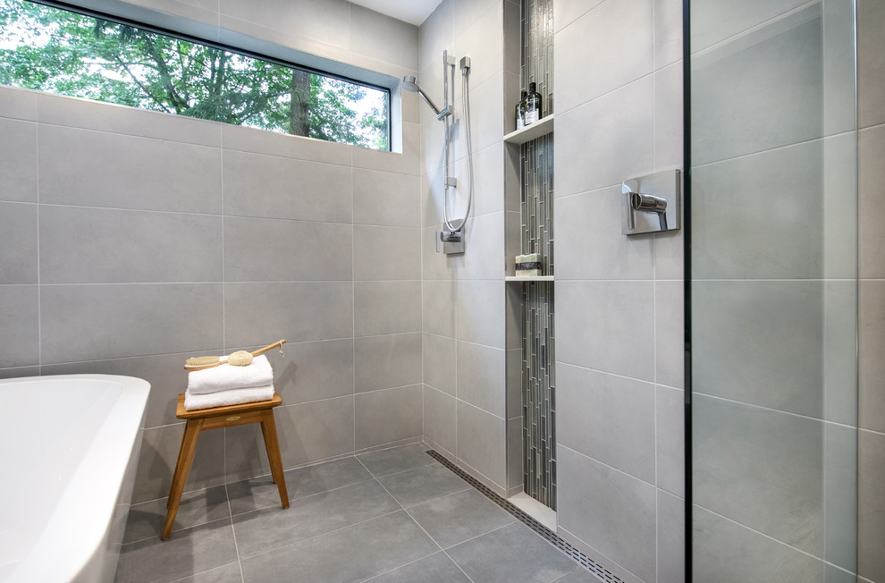 Freestanding bathtub - mid-sized transitional master gray tile and porcelain tile porcelain tile freestanding bathtub idea in Seattle with shaker cabinets, gray cabinets, a two-piece toilet, white walls, an undermount sink and quartzite countertops