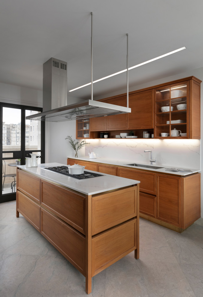 Inspiration for a mid-sized contemporary galley eat-in kitchen in Other with an undermount sink, raised-panel cabinets, quartz benchtops, white splashback, engineered quartz splashback, stainless steel appliances, marble floors, grey floor, white benchtop, medium wood cabinets and with island.