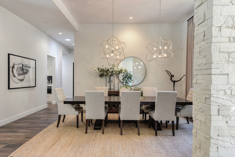 This is an example of a large contemporary open plan dining in Sacramento with white walls, dark hardwood floors and brown floor.