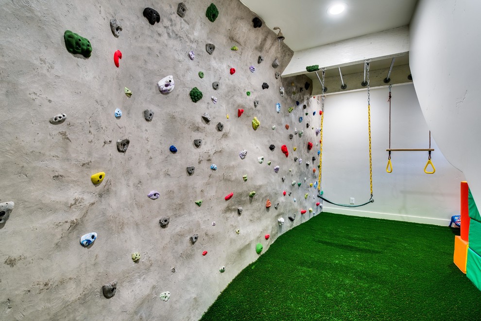 Mid-sized eclectic home climbing wall in Boise with white walls and green floor.