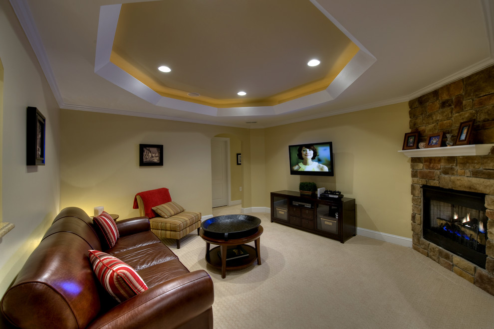 Design ideas for an expansive contemporary fully buried basement in DC Metro with a stone fireplace surround, a standard fireplace, yellow walls and carpet.