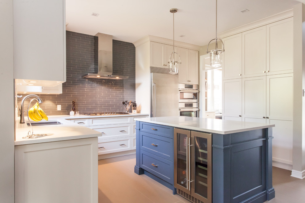 Eat-in kitchen - large transitional u-shaped porcelain tile and gray floor eat-in kitchen idea in Toronto with an undermount sink, recessed-panel cabinets, white cabinets, quartz countertops, gray backsplash, subway tile backsplash, stainless steel appliances, an island and white countertops
