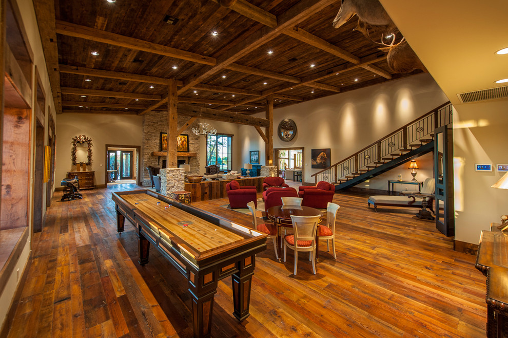 Design ideas for a country open concept family room in Austin with a game room, beige walls and dark hardwood floors.