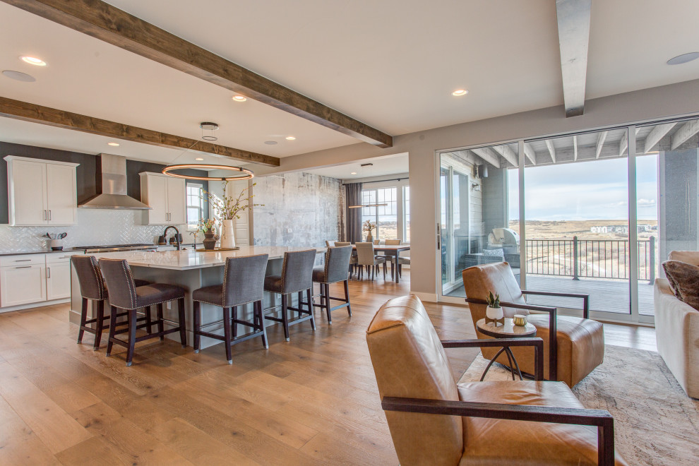 Inspiration for a large transitional light wood floor kitchen remodel in Denver with shaker cabinets, white cabinets, quartz countertops and an island