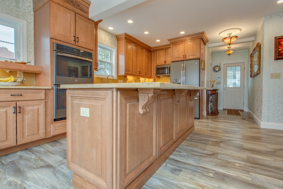 Inspiration for a large traditional l-shaped separate kitchen in Boston with an undermount sink, raised-panel cabinets, medium wood cabinets, granite benchtops, yellow splashback, stone slab splashback, stainless steel appliances, with island, light hardwood floors and brown floor.