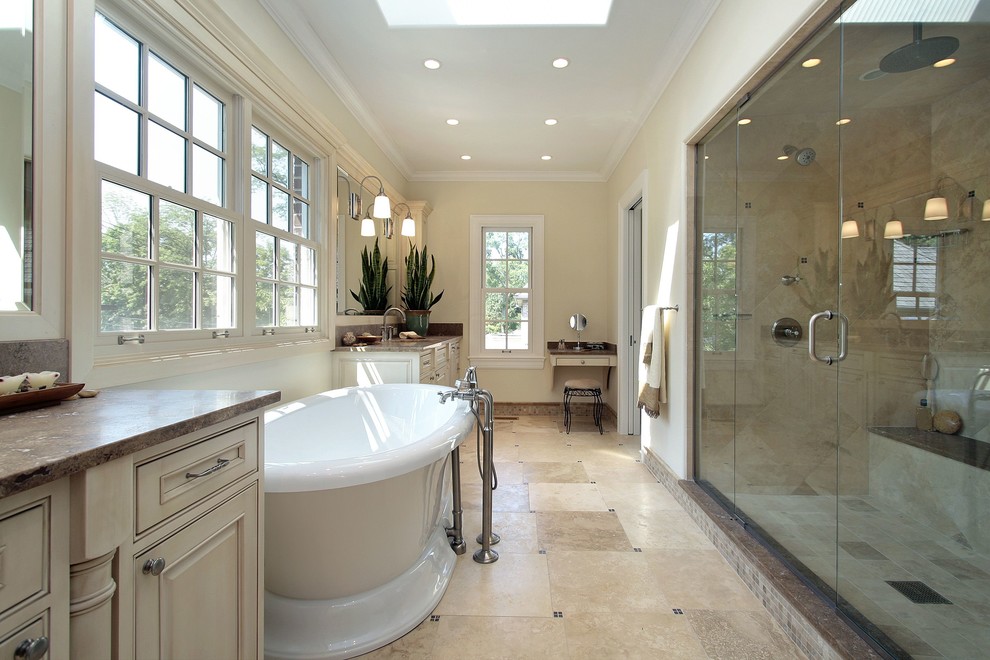 Inspiration for a large transitional master bathroom in Dallas with raised-panel cabinets, beige cabinets, a freestanding tub, an alcove shower, beige tile, cement tile, yellow walls, porcelain floors, engineered quartz benchtops, beige floor, a hinged shower door, brown benchtops, a double vanity and a built-in vanity.