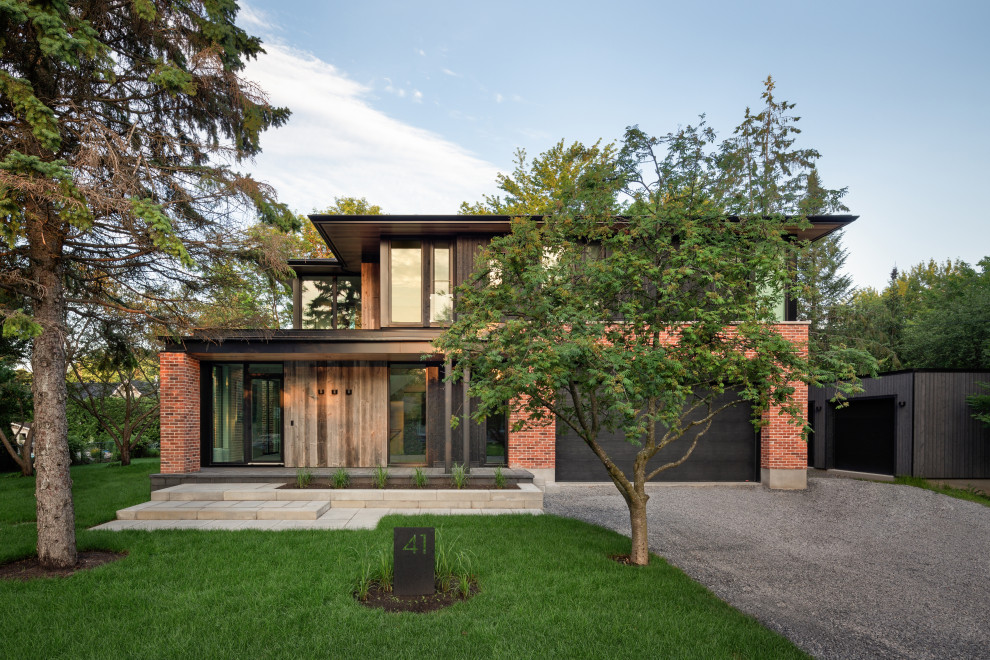 Design ideas for a contemporary two-storey brick red house exterior in Ottawa.