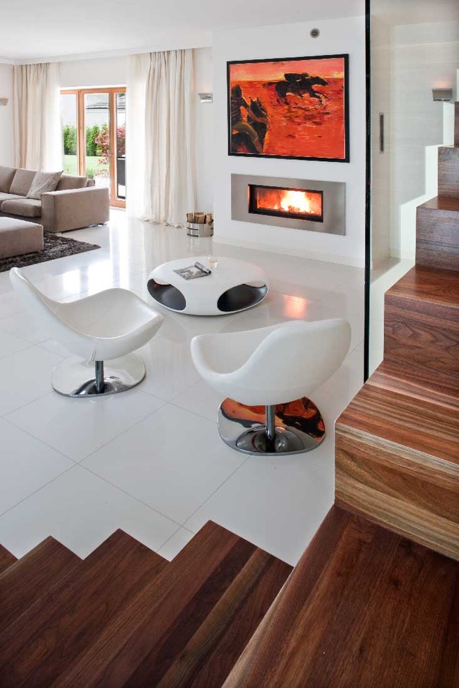 Photo of a modern living room in Other with white walls and a ribbon fireplace.
