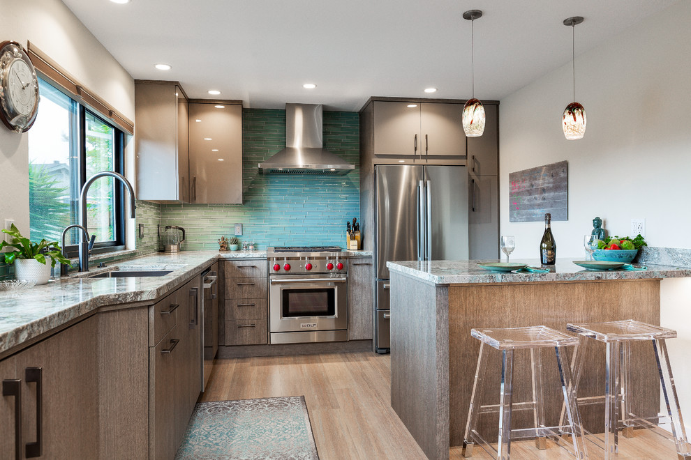 Inspiration for a mid-sized contemporary eat-in kitchen in Other with a single-bowl sink, flat-panel cabinets, quartz benchtops, green splashback, glass tile splashback, stainless steel appliances, bamboo floors, with island and turquoise benchtop.