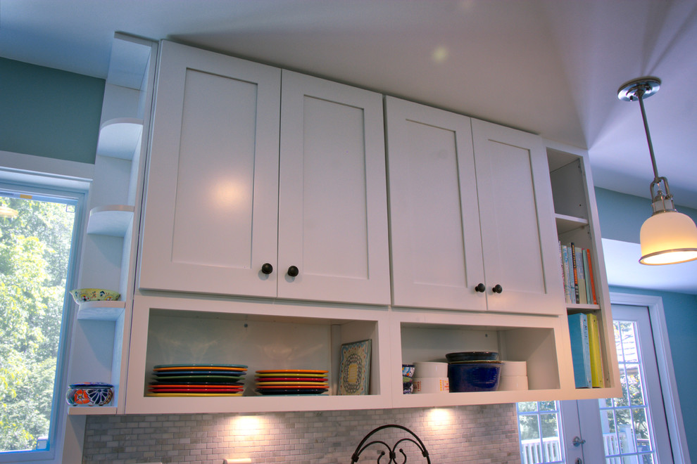Mid-sized transitional u-shaped dark wood floor and brown floor kitchen photo in DC Metro with an undermount sink, shaker cabinets, white cabinets, quartz countertops, gray backsplash, matchstick tile backsplash, stainless steel appliances and a peninsula