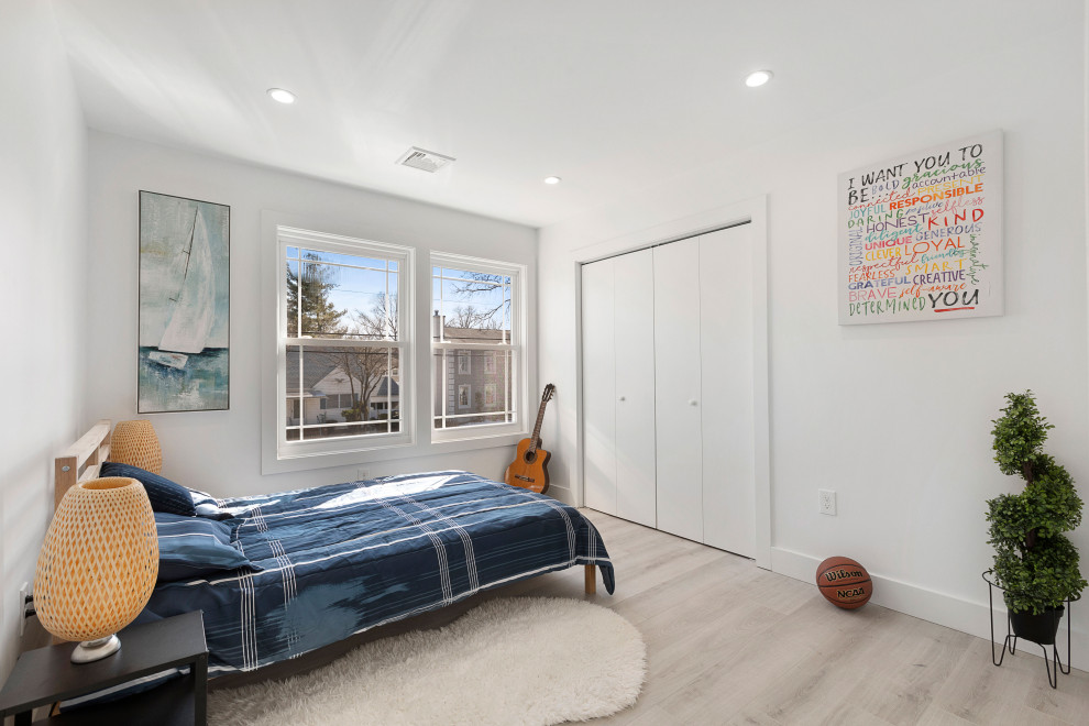 Modern Residential Construction - Inspiration for a bedroom and mid-sized modern boy light wood floor, brown floor, shiplap ceiling and wall paneling kids' bedroom remodel in Newark with white walls