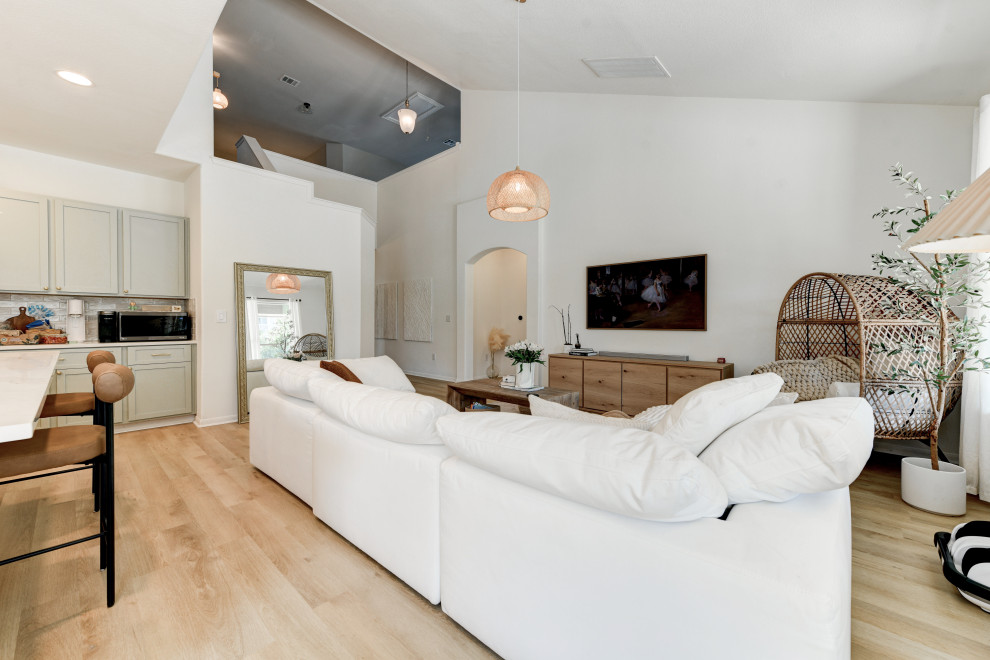 Mittelgroßes, Repräsentatives, Offenes Klassisches Wohnzimmer ohne Kamin mit weißer Wandfarbe, Vinylboden, TV-Wand, beigem Boden und gewölbter Decke in Austin