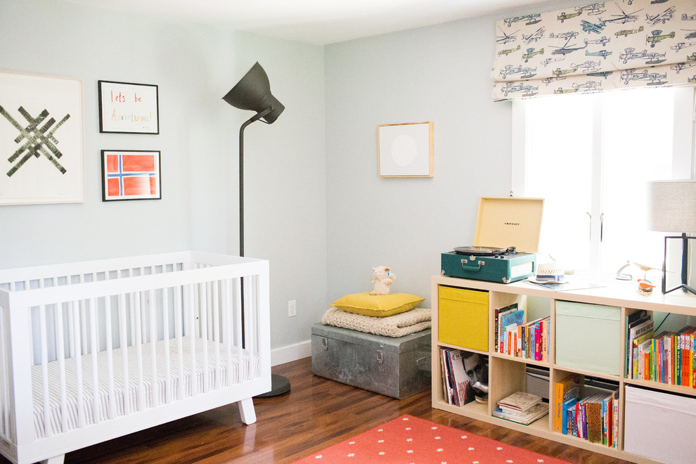This is an example of a small transitional gender-neutral nursery in Boston with grey walls, dark hardwood floors and brown floor.