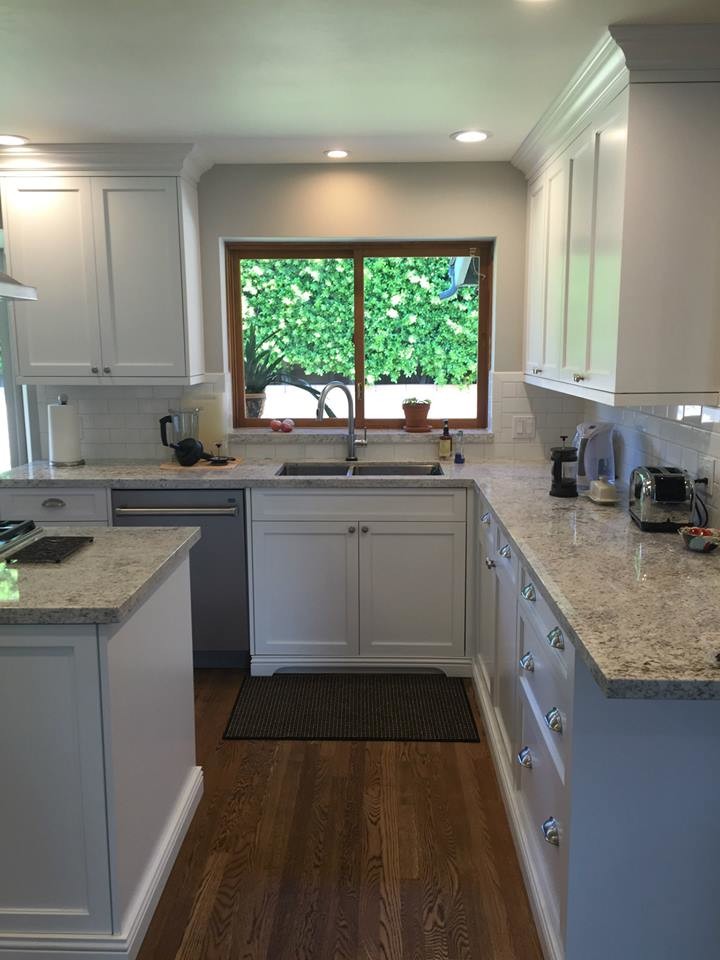 Kitchen - large transitional medium tone wood floor kitchen idea in Phoenix with an undermount sink, shaker cabinets, white cabinets, granite countertops, white backsplash, subway tile backsplash, stainless steel appliances and an island