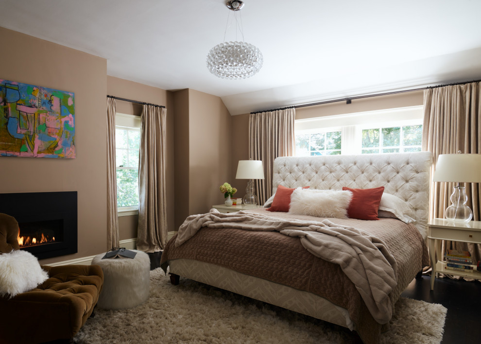 Design ideas for a large transitional master bedroom in Boston with beige walls, dark hardwood floors, a standard fireplace, a metal fireplace surround and black floor.