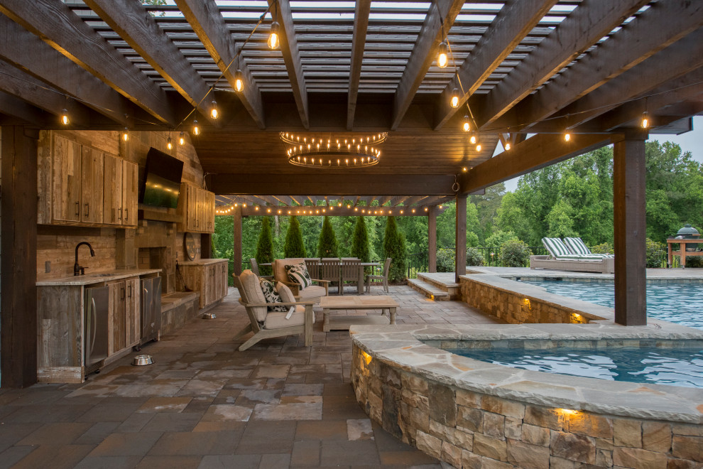 Inspiration for an expansive transitional backyard patio in Atlanta with brick pavers, with fireplace and a pergola.