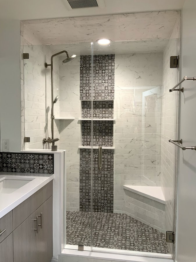 This is an example of a small modern master bathroom in Los Angeles with flat-panel cabinets, grey cabinets, an alcove shower, multi-coloured tile, mosaic tile, white walls, vinyl floors, an undermount sink, engineered quartz benchtops, a hinged shower door and white benchtops.