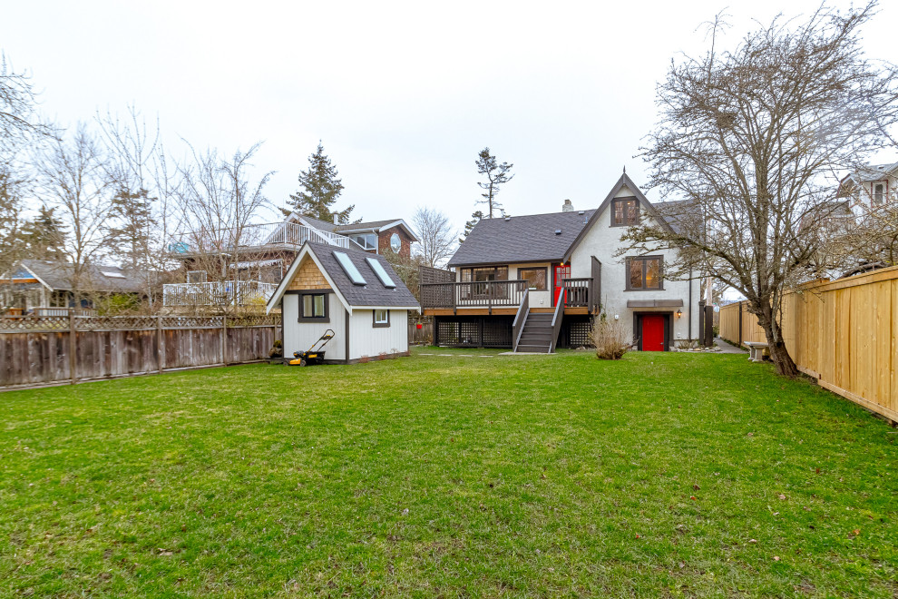 Mid-sized transitional backyard second story privacy and wood railing deck photo