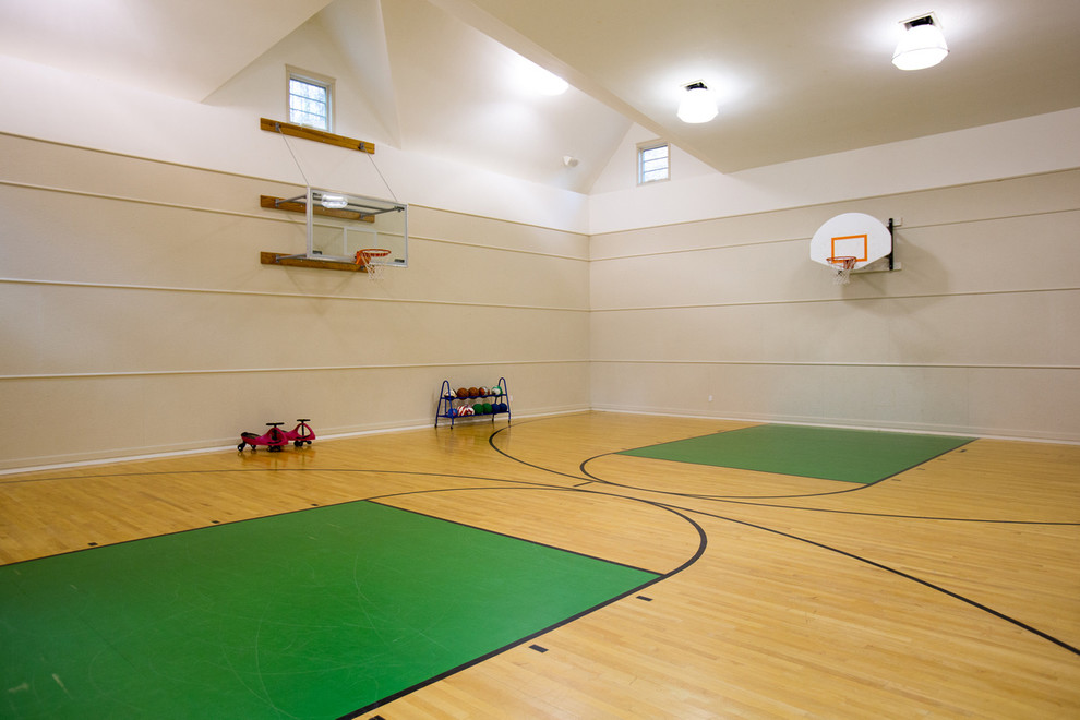 Expansive contemporary indoor sport court in Boston with beige walls and light hardwood floors.