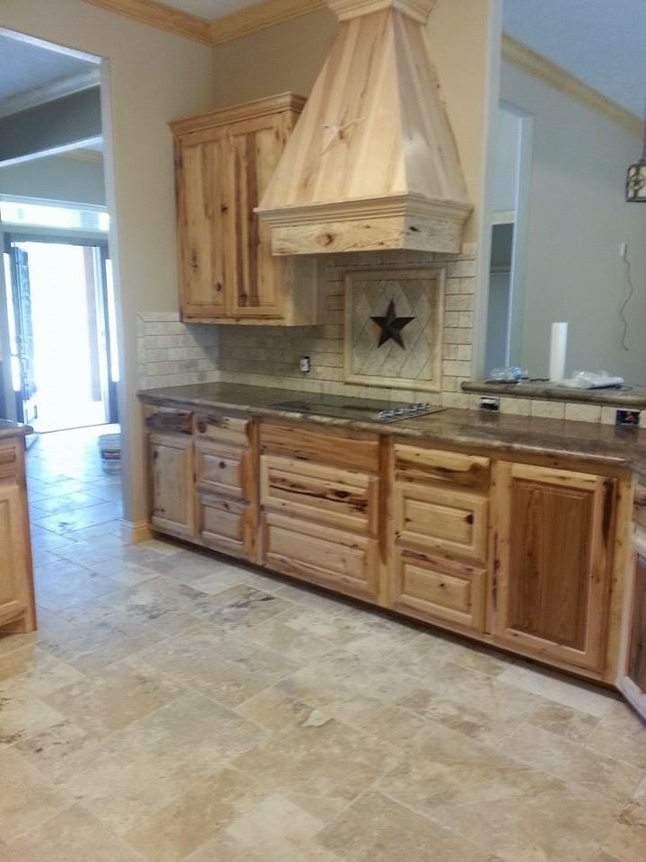 Large mountain style u-shaped ceramic tile eat-in kitchen photo in Austin with a drop-in sink, raised-panel cabinets, medium tone wood cabinets, granite countertops, multicolored backsplash, mosaic tile backsplash, stainless steel appliances and an island