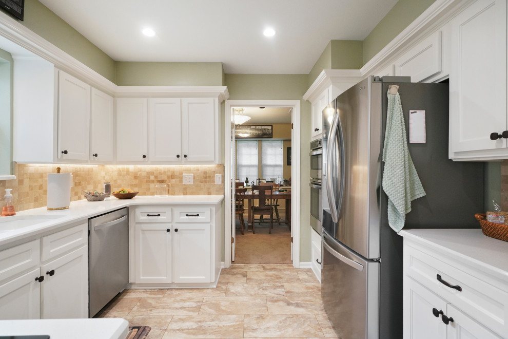 Mid-sized trendy galley ceramic tile, beige floor and coffered ceiling eat-in kitchen photo in Houston with a double-bowl sink, flat-panel cabinets, white cabinets, quartzite countertops, beige backsplash, ceramic backsplash, stainless steel appliances, no island and white countertops