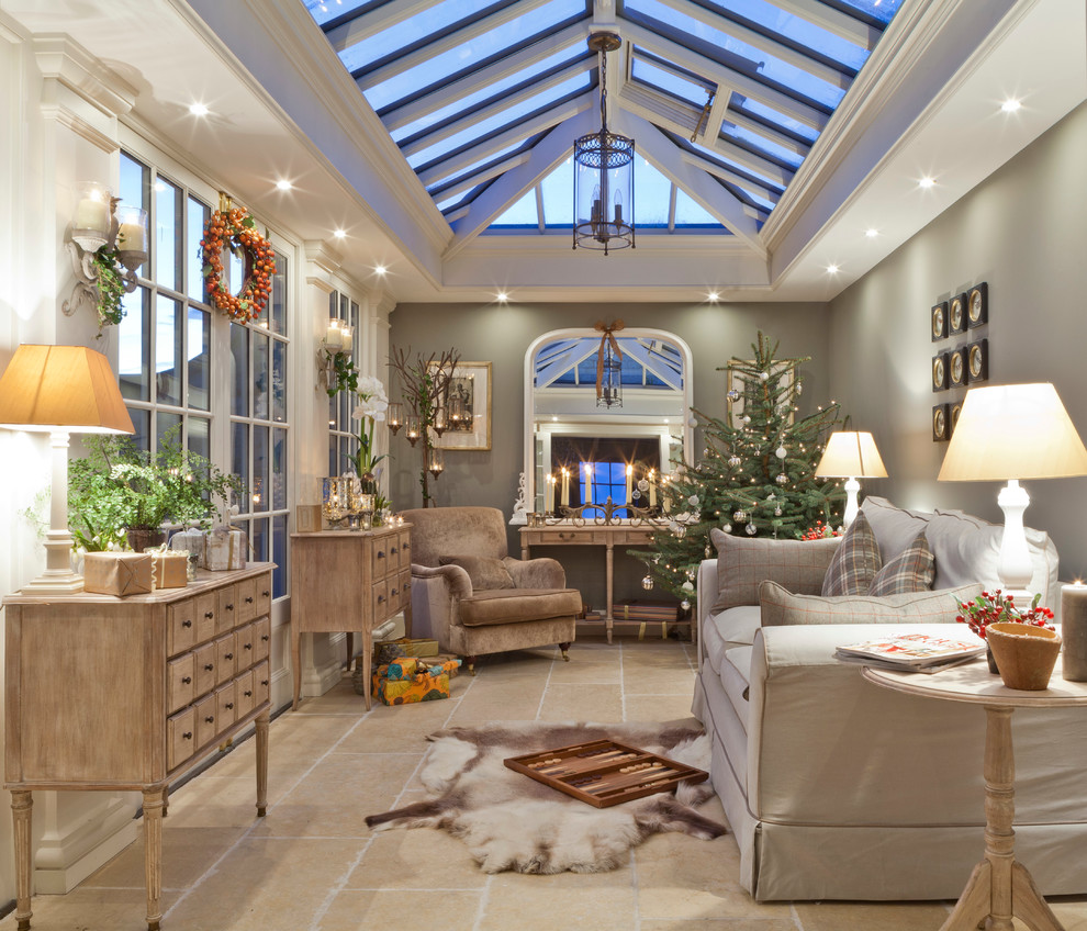 This is an example of a mid-sized traditional sunroom in Other with travertine floors, a skylight and beige floor.