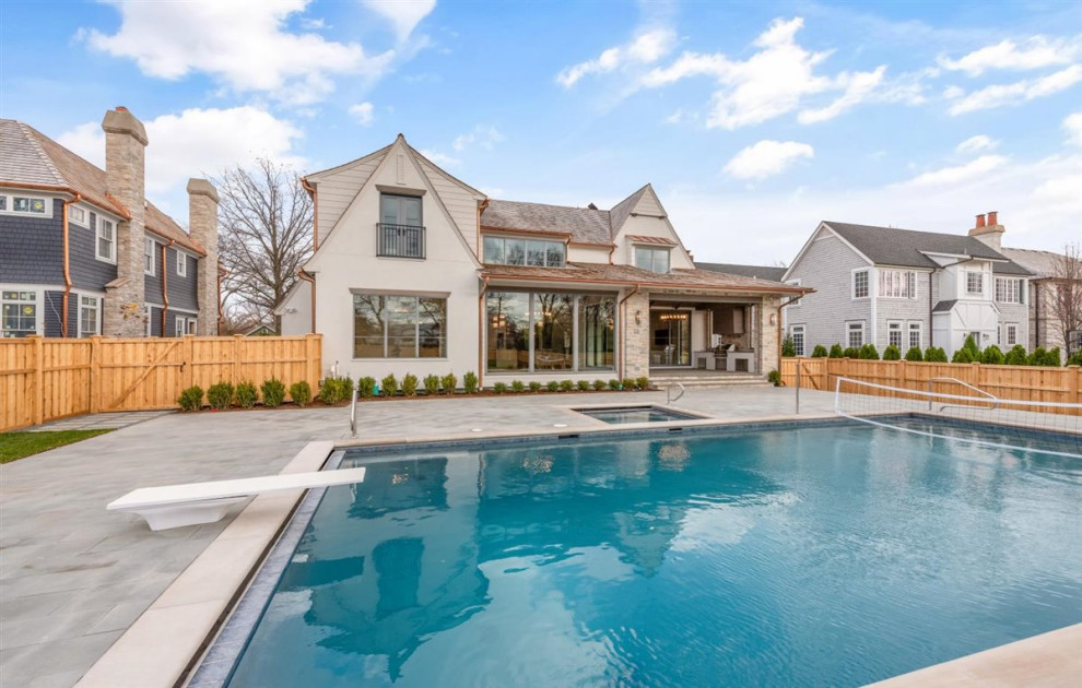 Huge transitional white three-story stone and clapboard house exterior photo in Chicago with a shed roof, a mixed material roof and a brown roof