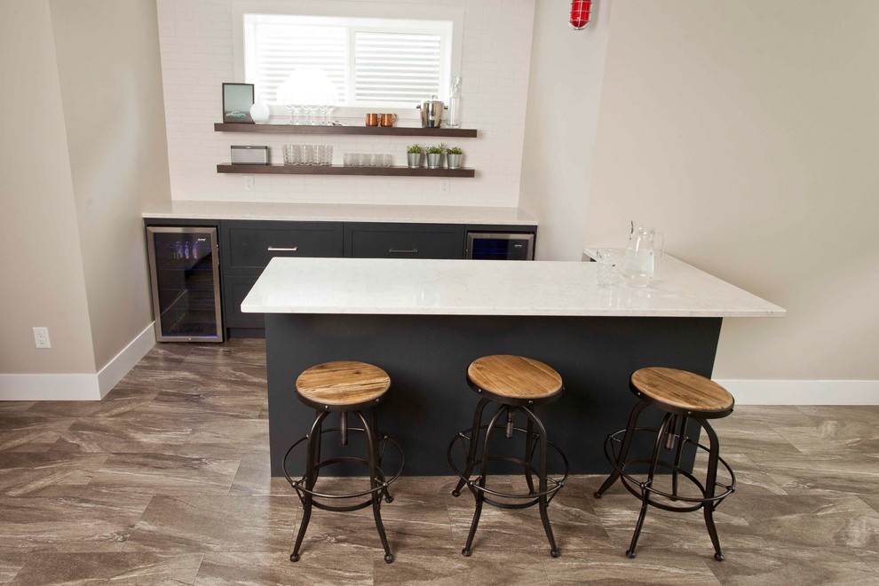 This is an example of a mid-sized contemporary single-wall seated home bar in Calgary with no sink, black cabinets, granite benchtops, porcelain floors, brown floor and white benchtop.