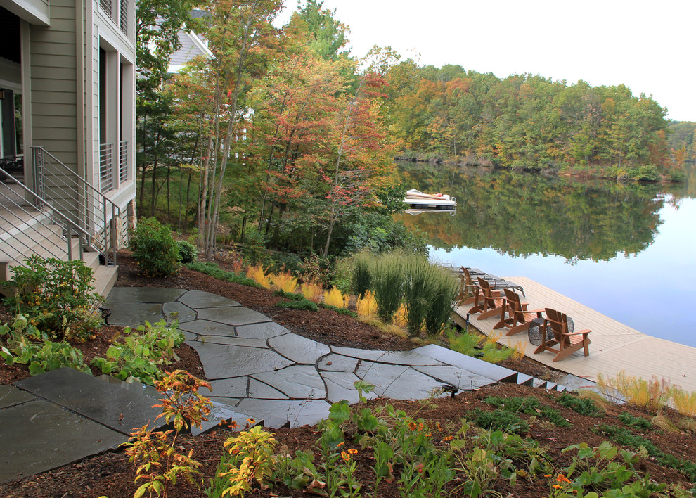 Inspiration for a beach style sloped partial sun garden for fall in DC Metro with natural stone pavers.