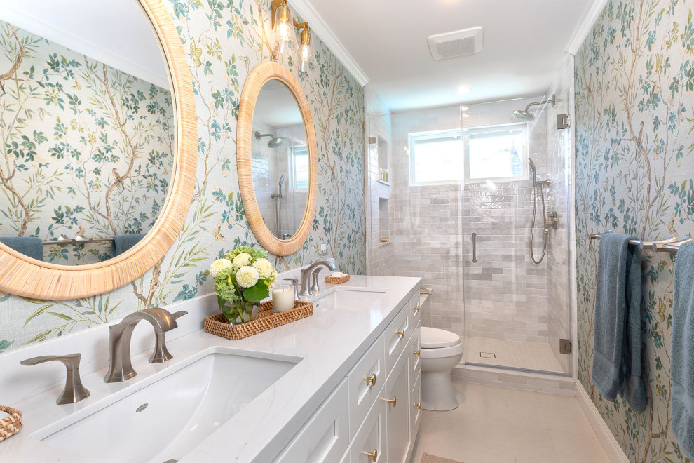 Inspiration for a mid-sized transitional 3/4 beige floor, double-sink and wallpaper alcove shower remodel in Los Angeles with shaker cabinets, white cabinets, an undermount sink, quartz countertops, a hinged shower door, white countertops, a niche and a built-in vanity