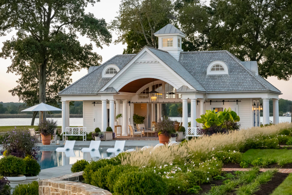 Large elegant backyard brick and custom-shaped pool house photo in Baltimore