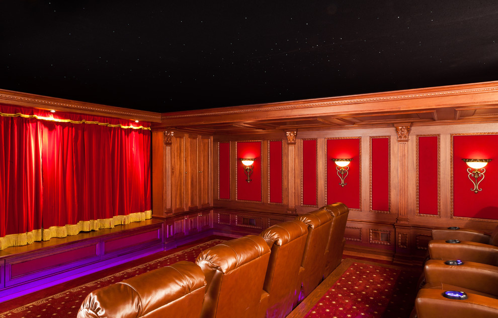 Mid-sized traditional enclosed home theatre in New York with brown walls, a built-in media wall, carpet and red floor.