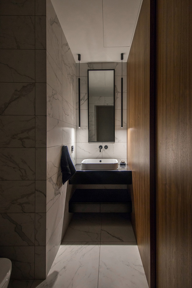 Photo of a mid-sized contemporary powder room in Other with open cabinets, gray tile, porcelain tile, brown walls, porcelain floors, a vessel sink, grey floor, blue benchtops and a built-in vanity.