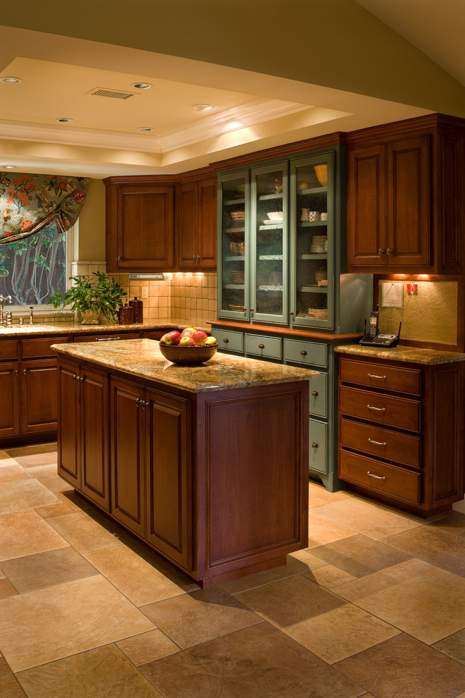 Inspiration for a large traditional l-shaped eat-in kitchen in Orange County with a double-bowl sink, raised-panel cabinets, medium wood cabinets, granite benchtops, beige splashback, stone tile splashback, stainless steel appliances, travertine floors and with island.