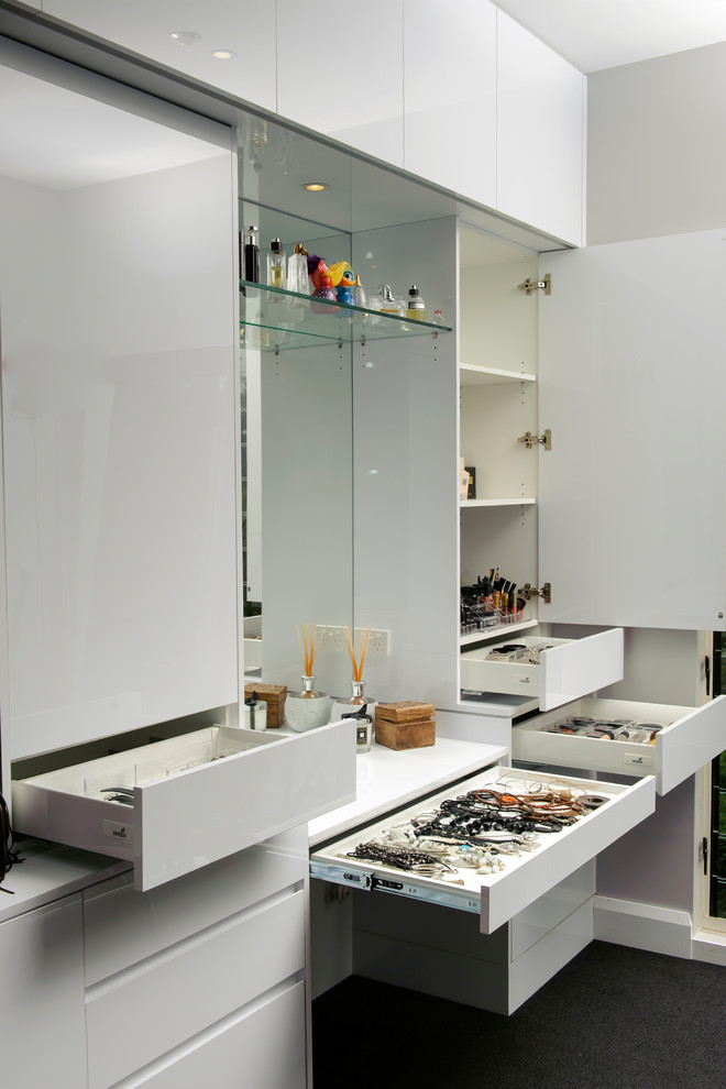 Inspiration for a modern storage and wardrobe in Sydney with white cabinets.