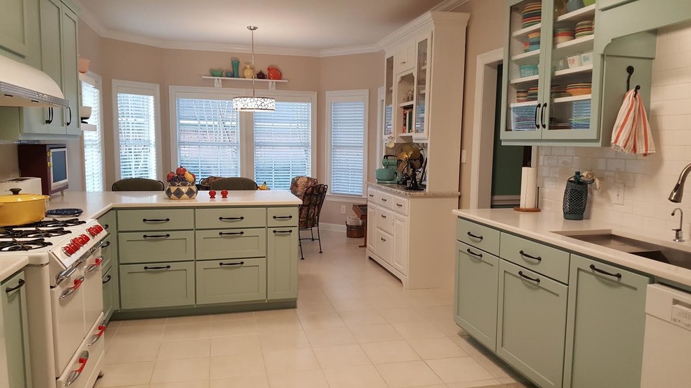 Inspiration for a mid-sized midcentury eat-in kitchen in Miami with an undermount sink, shaker cabinets, blue cabinets, quartzite benchtops, white splashback, subway tile splashback, white appliances, ceramic floors, a peninsula and beige floor.