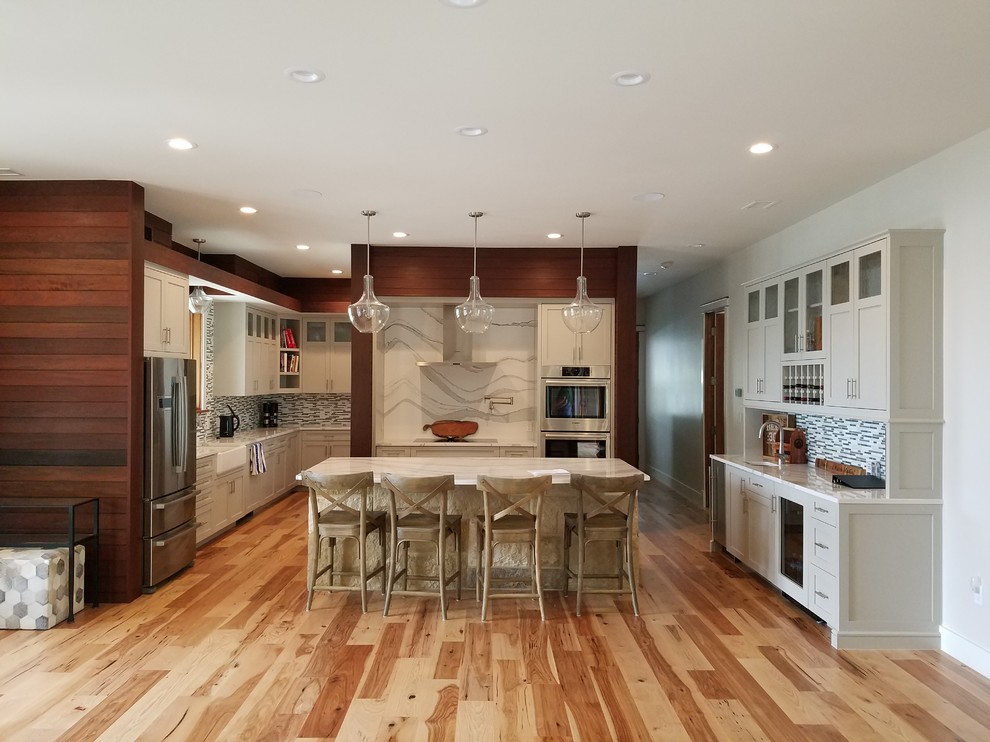 Design ideas for a contemporary kitchen in Austin with shaker cabinets, medium hardwood floors, with island and beige cabinets.