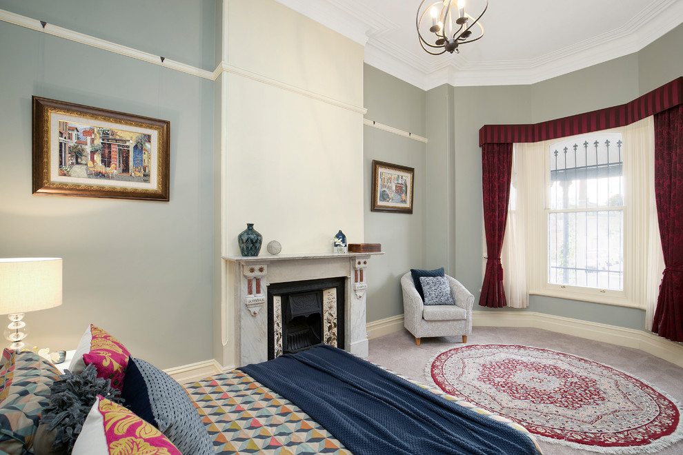 Photo of a traditional guest bedroom in Sydney with carpet, green walls, a standard fireplace, a stone fireplace surround and purple floor.