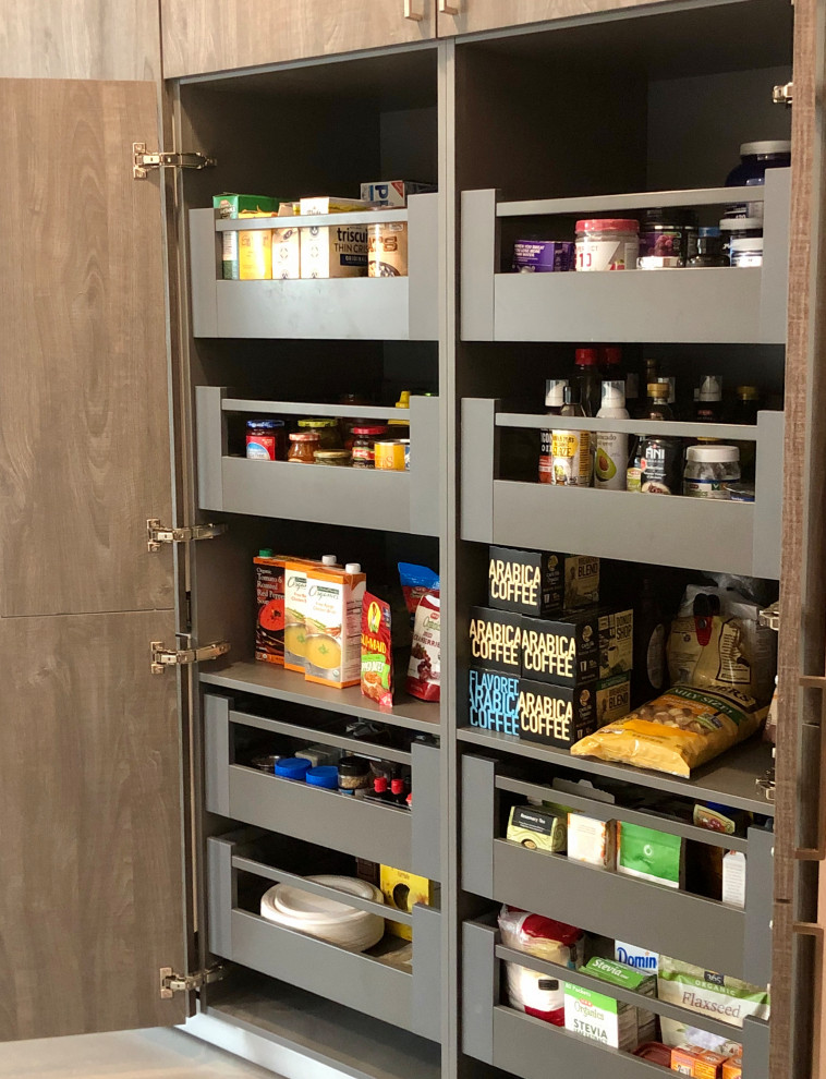 This is an example of a transitional kitchen pantry in Houston with flat-panel cabinets, white cabinets, grey splashback, porcelain splashback, porcelain floors, grey floor and yellow benchtop.