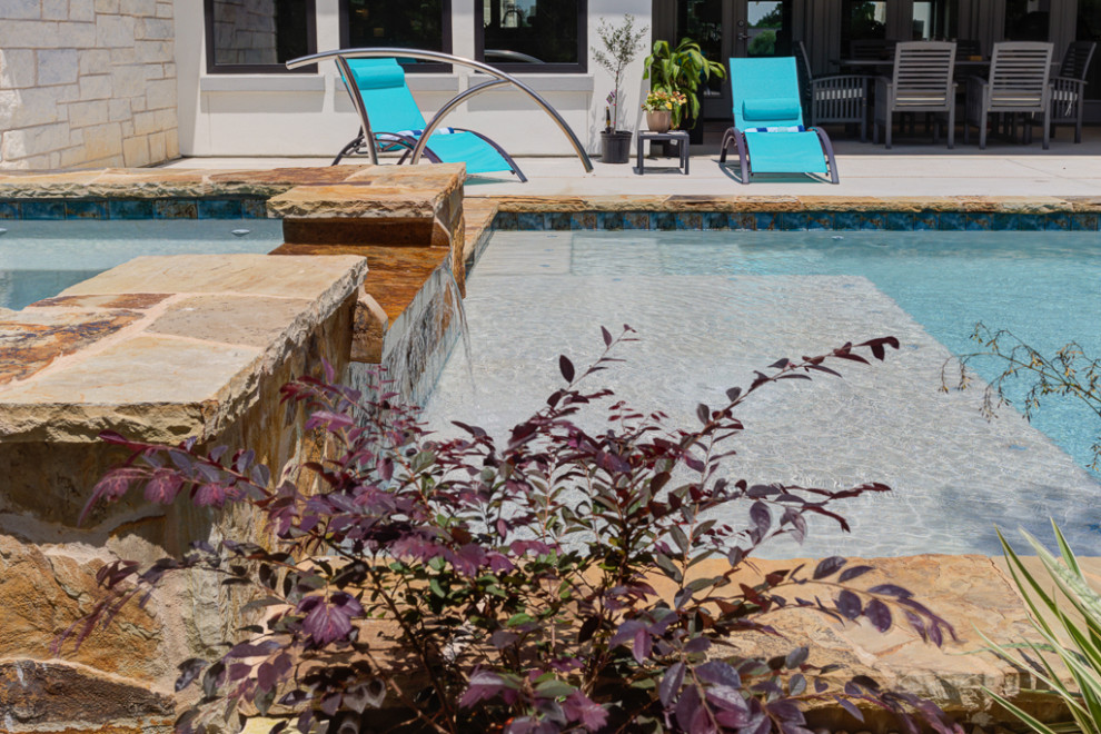 Example of a mid-sized transitional backyard rectangular natural hot tub design in Austin with decking
