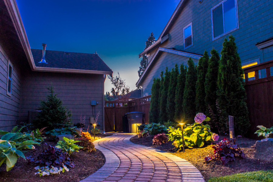 Inspiration for a mid-sized traditional side yard partial sun garden for summer in Seattle with a garden path and brick pavers.