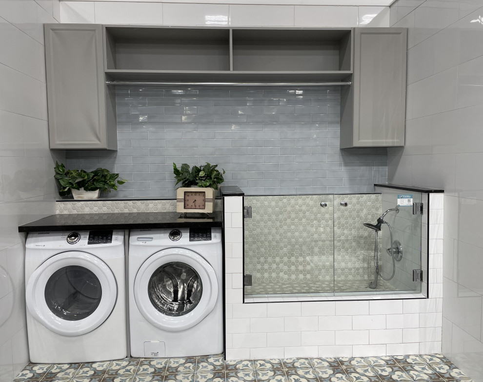 Small galley utility room in Seattle with grey cabinets, engineered stone countertops, ceramic flooring, a side by side washer and dryer and grey worktops.