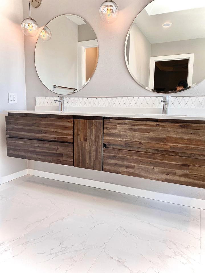 Design ideas for a large modern master bathroom in Seattle with flat-panel cabinets, medium wood cabinets, a freestanding tub, a corner shower, white tile, ceramic tile, white walls, ceramic floors, quartzite benchtops, white floor, a hinged shower door and white benchtops.