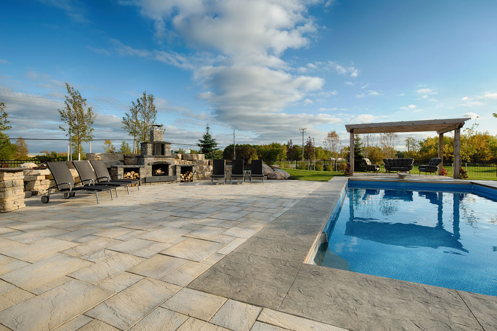 Design ideas for an expansive country backyard rectangular pool in Other with concrete pavers.
