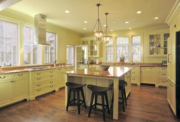 Design ideas for a mid-sized traditional u-shaped separate kitchen in DC Metro with an undermount sink, recessed-panel cabinets, white cabinets, granite benchtops, panelled appliances, medium hardwood floors, with island and brown floor.