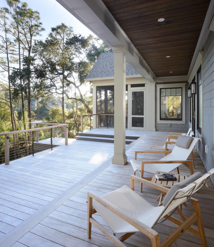 Large transitional backyard deck in Charleston with a roof extension.