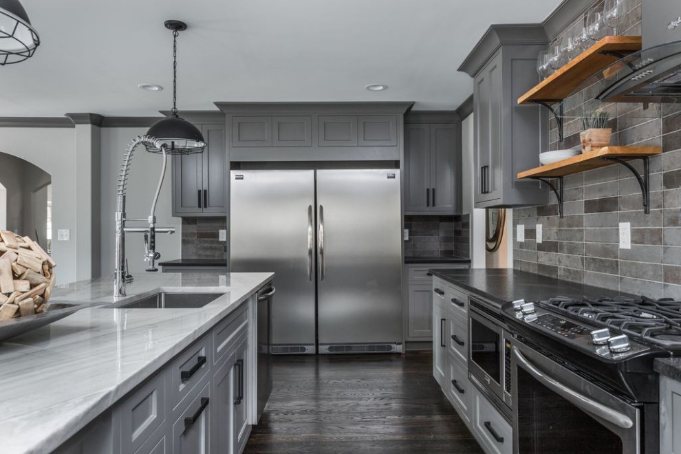 Design ideas for a large modern kitchen in Indianapolis with an undermount sink, shaker cabinets, grey cabinets, granite benchtops, grey splashback, ceramic splashback, stainless steel appliances, dark hardwood floors, with island, brown floor and black benchtop.