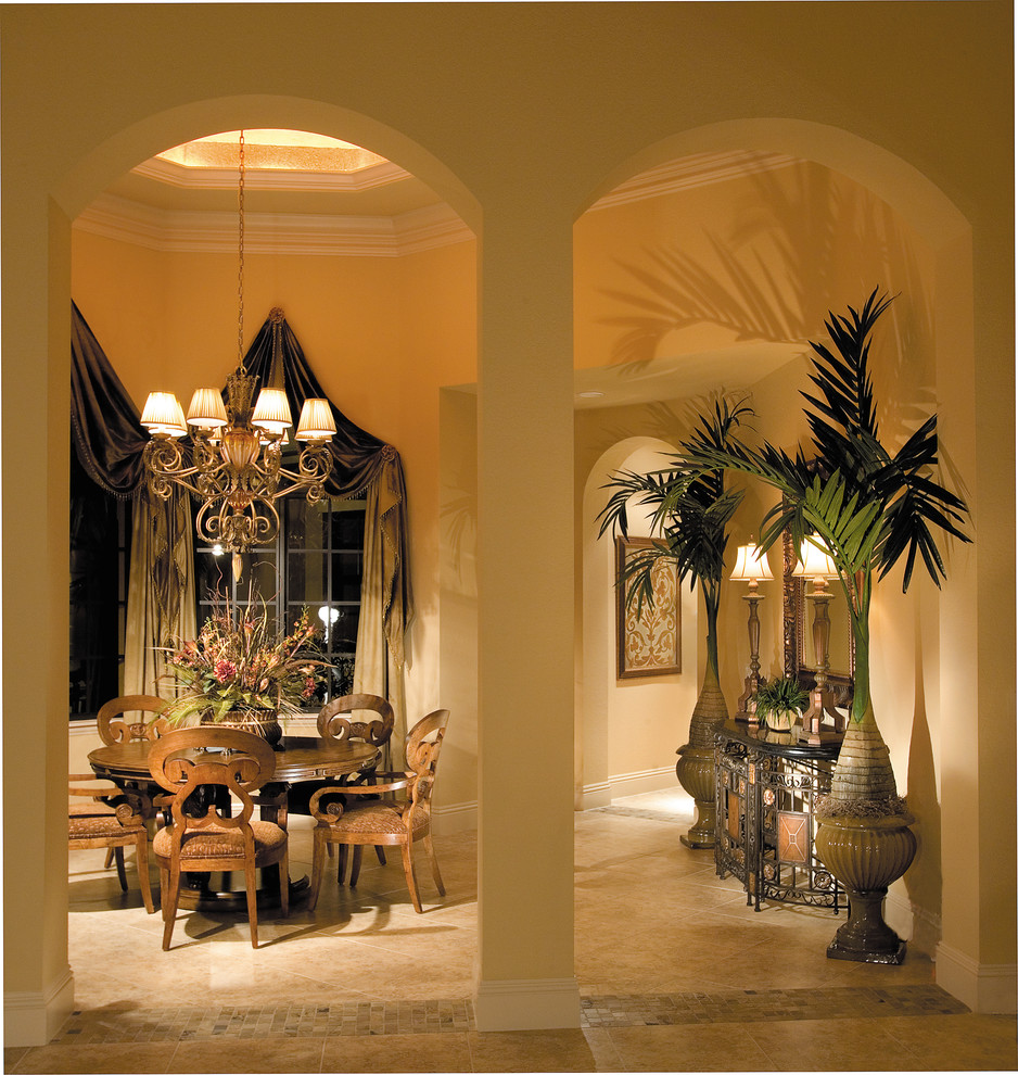 Design ideas for a mid-sized mediterranean separate dining room in Miami with beige walls, travertine floors and no fireplace.